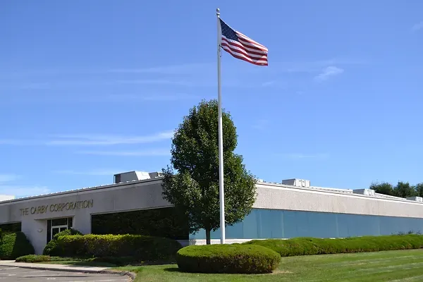 exterior of The Carby Corporation in Watertown, CT with a flag pole in front of entrance
