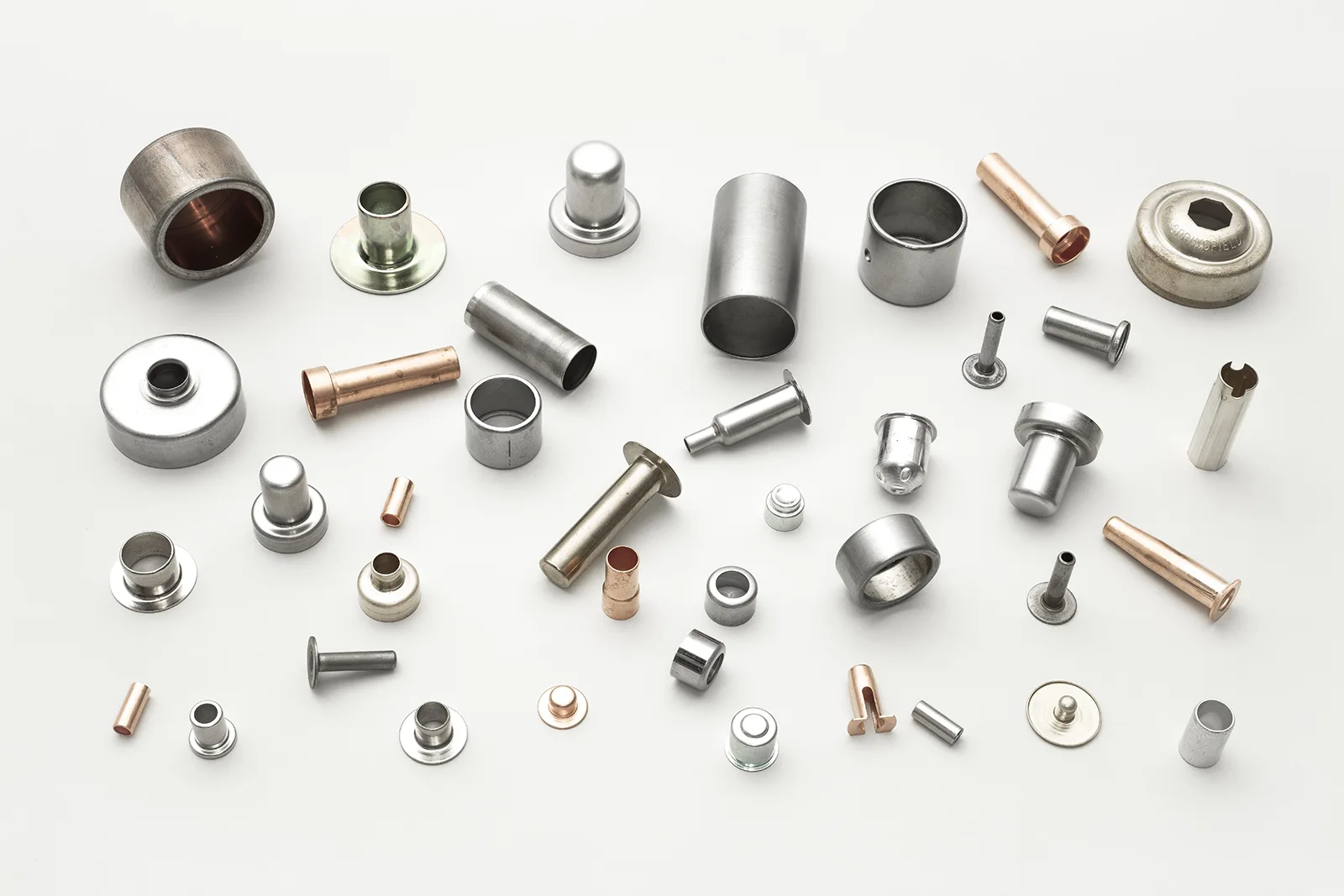 Assortment of small metal components from The Carby Corporation, a deep draw metal stamping manufacturer.